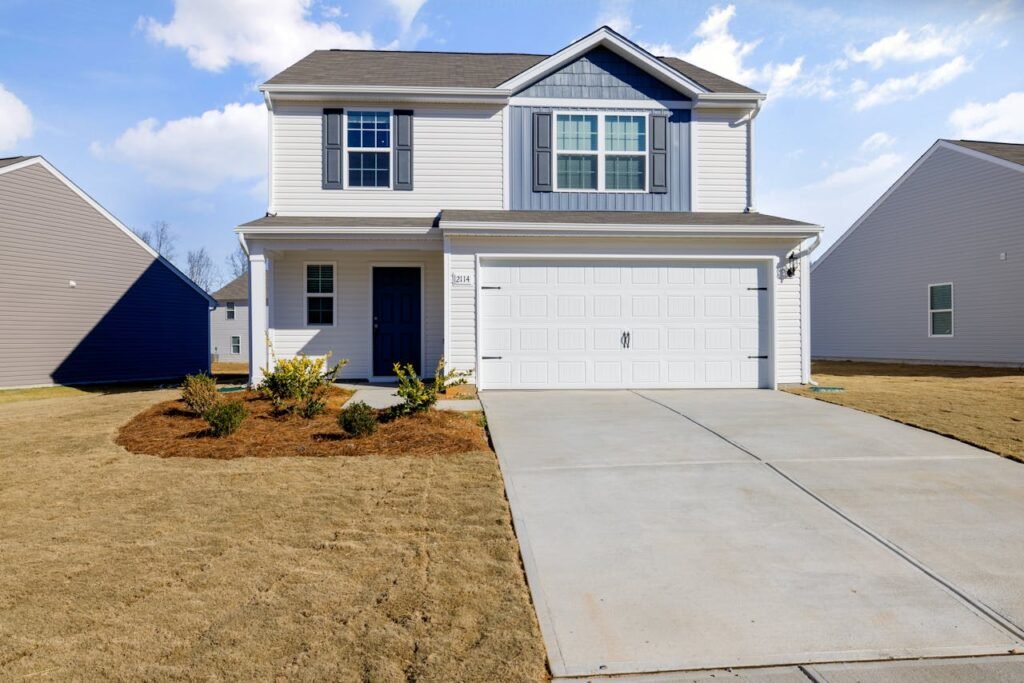 White and Blue House Under Blue Sky fix by Garage Door Repair Norwell, MA